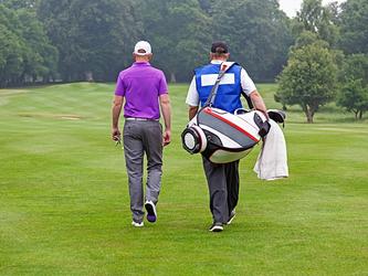 Golfer and caddy_crop